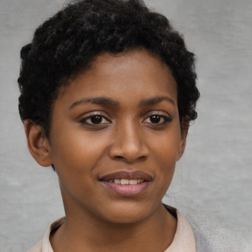 Joyful black young-adult female with short  brown hair and brown eyes