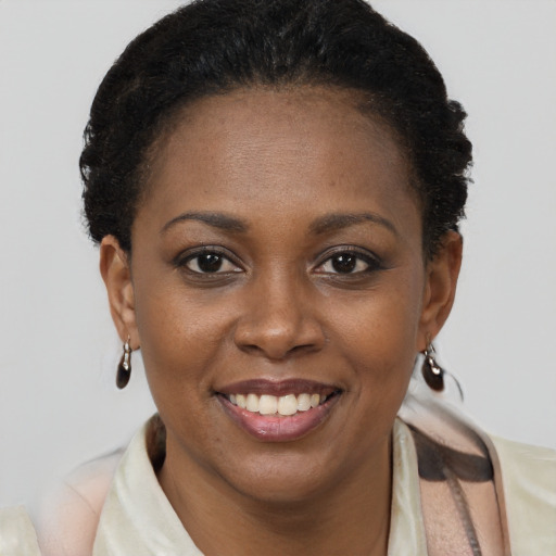 Joyful black young-adult female with short  brown hair and brown eyes