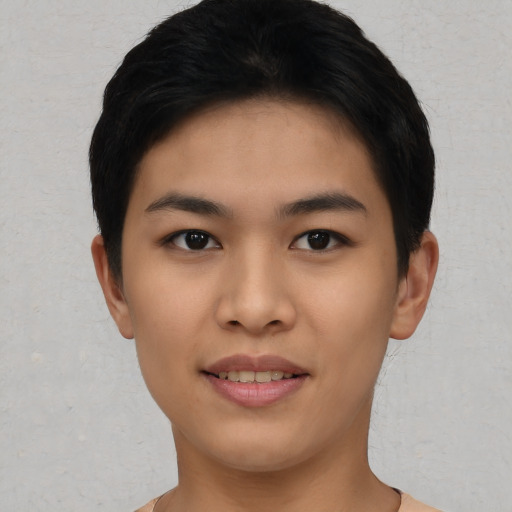 Joyful asian young-adult female with short  black hair and brown eyes