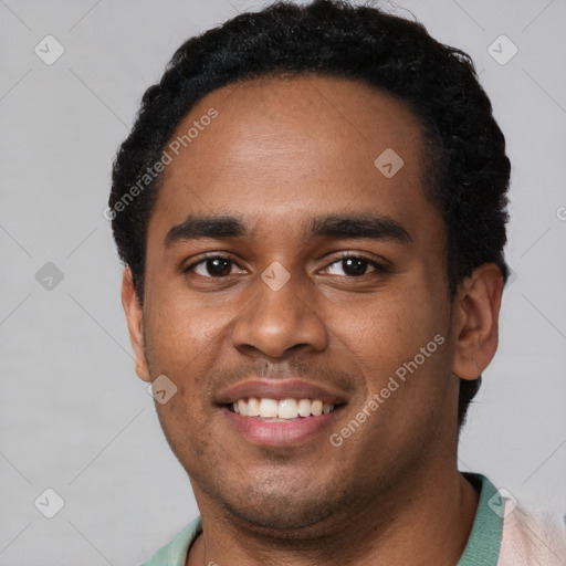 Joyful black young-adult male with short  black hair and brown eyes