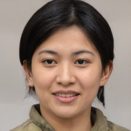 Joyful asian young-adult female with medium  brown hair and brown eyes