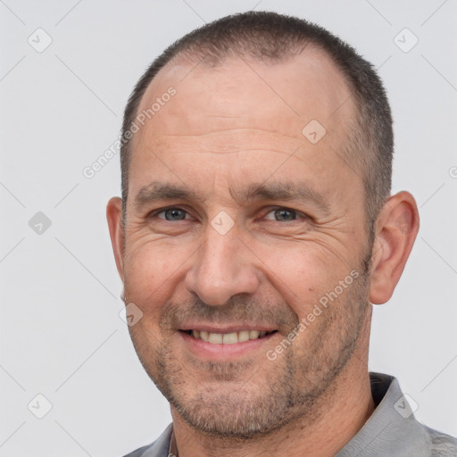 Joyful white adult male with short  brown hair and brown eyes