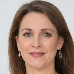 Joyful white adult female with long  brown hair and grey eyes