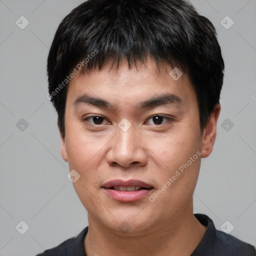 Joyful asian young-adult male with short  black hair and brown eyes