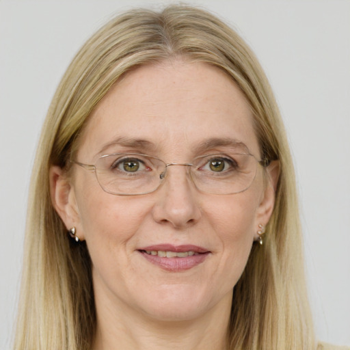 Joyful white adult female with long  brown hair and blue eyes