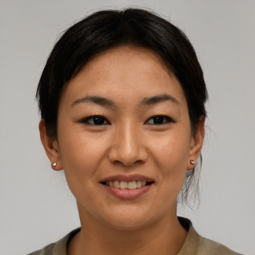 Joyful asian young-adult female with medium  brown hair and brown eyes