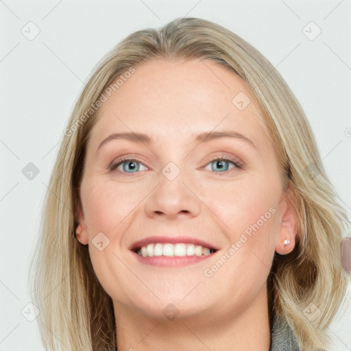 Joyful white young-adult female with long  brown hair and blue eyes