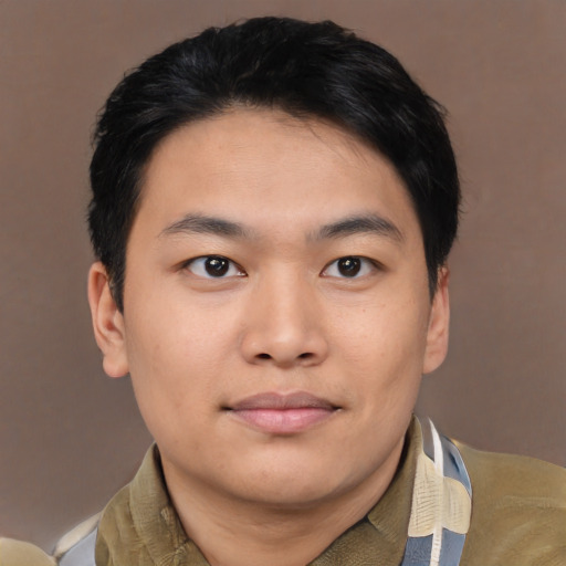 Joyful asian young-adult male with short  black hair and brown eyes