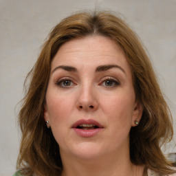 Joyful white young-adult female with medium  brown hair and green eyes