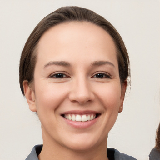 Joyful white young-adult female with medium  brown hair and brown eyes