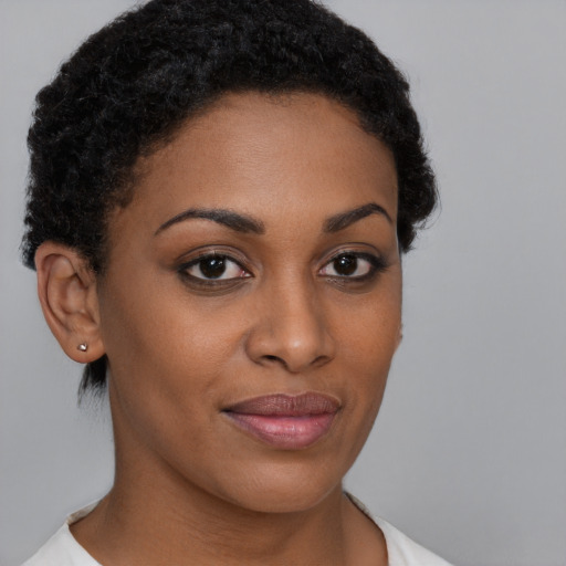 Joyful black young-adult female with short  brown hair and brown eyes