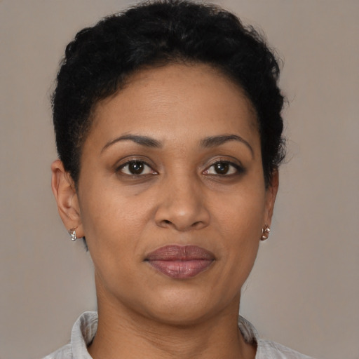Joyful latino young-adult female with short  black hair and brown eyes