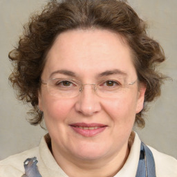 Joyful white adult female with medium  brown hair and blue eyes