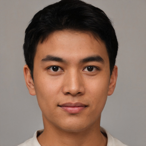 Joyful asian young-adult male with short  black hair and brown eyes