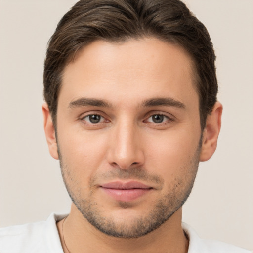 Joyful white young-adult male with short  brown hair and brown eyes