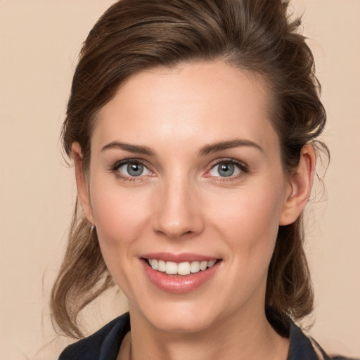 Joyful white young-adult female with medium  brown hair and grey eyes