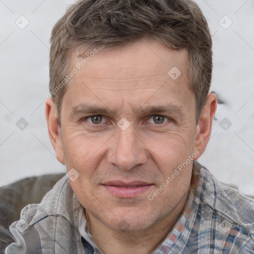 Joyful white adult male with short  brown hair and grey eyes