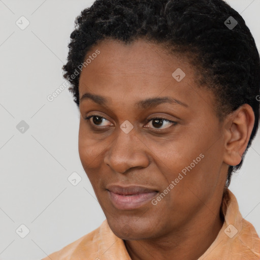 Joyful black young-adult female with short  black hair and brown eyes