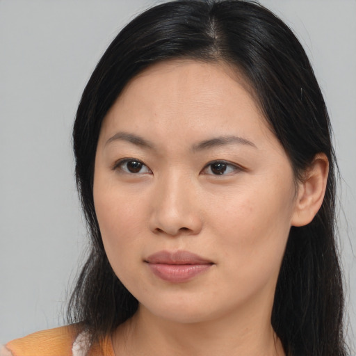 Joyful asian young-adult female with long  brown hair and brown eyes