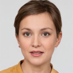 Joyful white young-adult female with short  brown hair and grey eyes