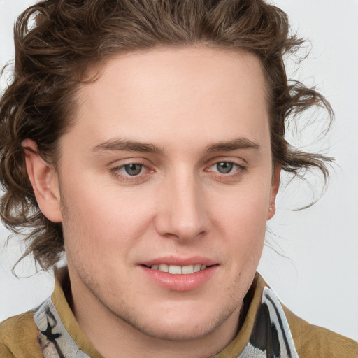 Joyful white young-adult male with medium  brown hair and blue eyes