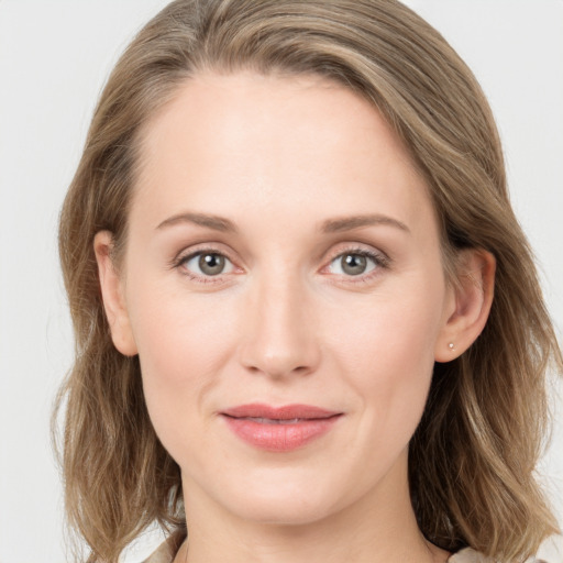 Joyful white young-adult female with long  brown hair and grey eyes