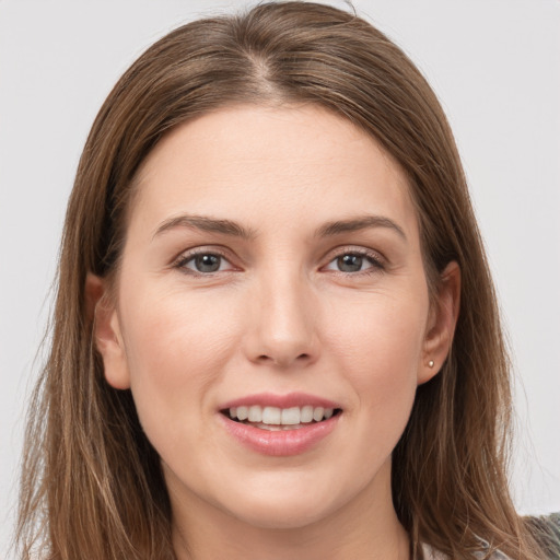 Joyful white young-adult female with long  brown hair and grey eyes