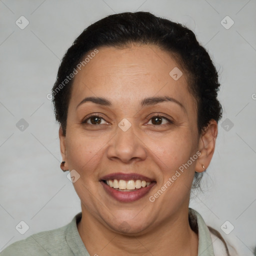 Joyful latino adult female with short  brown hair and brown eyes