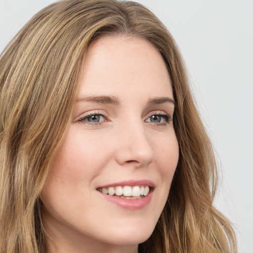 Joyful white young-adult female with long  brown hair and green eyes