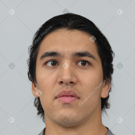 Neutral latino young-adult male with short  black hair and brown eyes