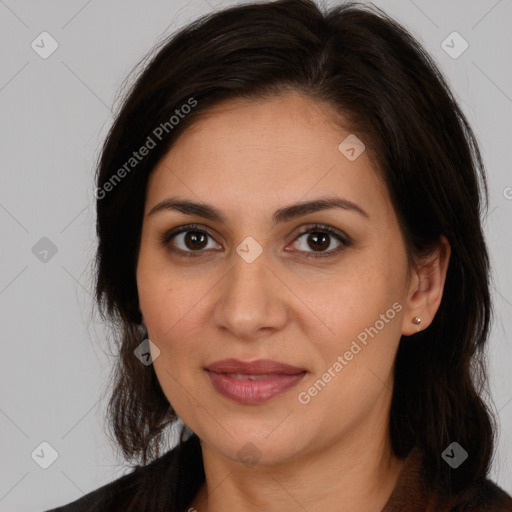 Joyful white adult female with long  brown hair and brown eyes