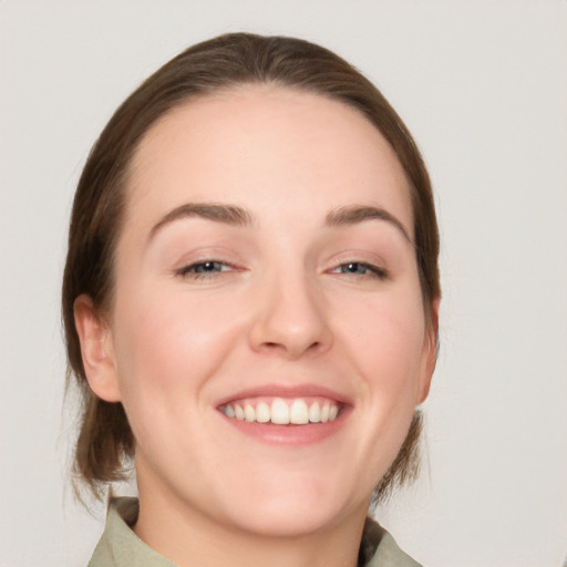 Joyful white young-adult female with medium  brown hair and blue eyes