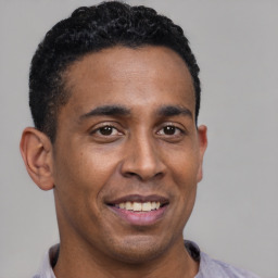 Joyful latino young-adult male with short  brown hair and brown eyes