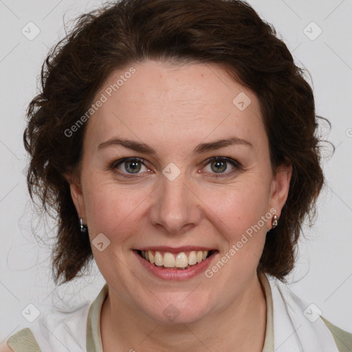 Joyful white adult female with medium  brown hair and green eyes