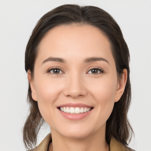 Joyful white young-adult female with medium  brown hair and brown eyes