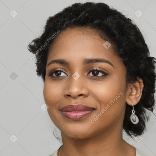 Joyful black young-adult female with long  black hair and brown eyes