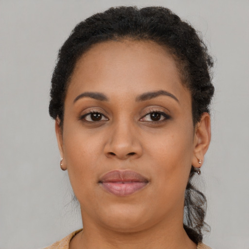 Joyful black young-adult female with short  brown hair and brown eyes