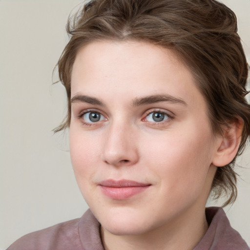 Joyful white young-adult female with medium  brown hair and blue eyes