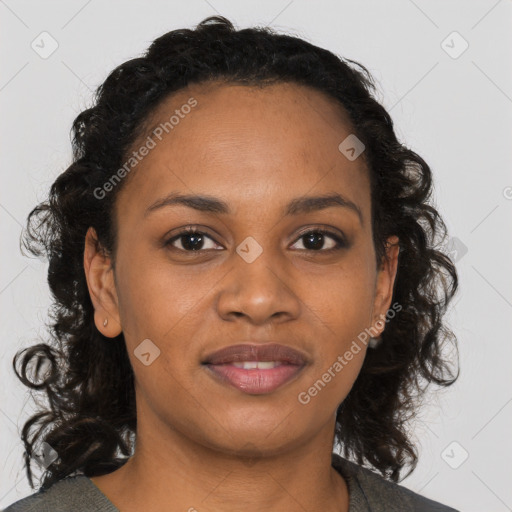 Joyful black young-adult female with long  brown hair and brown eyes