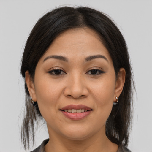 Joyful asian young-adult female with medium  brown hair and brown eyes