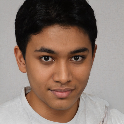 Joyful latino young-adult male with short  brown hair and brown eyes