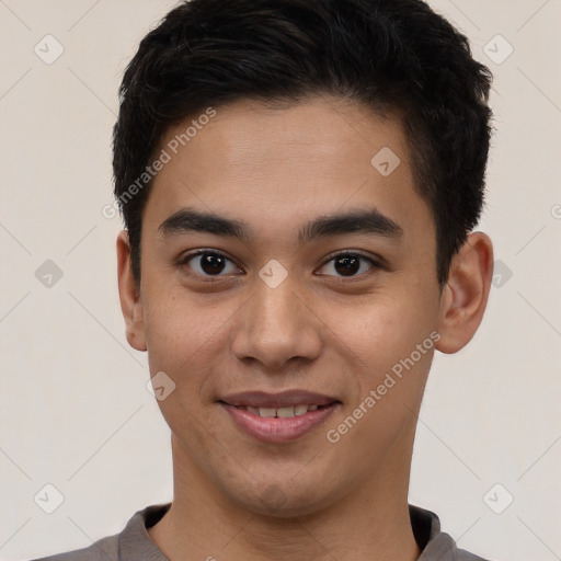 Joyful latino young-adult male with short  brown hair and brown eyes