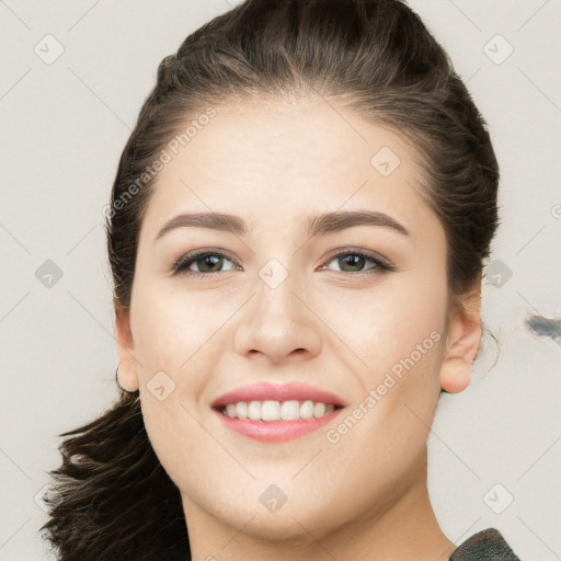 Joyful white young-adult female with long  brown hair and brown eyes