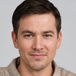 Joyful white adult male with short  brown hair and grey eyes