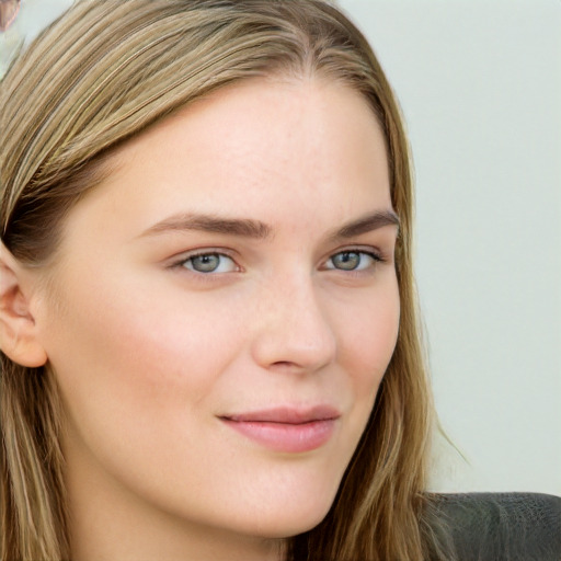 Joyful white young-adult female with long  brown hair and blue eyes