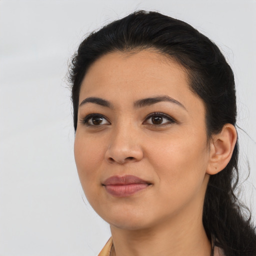 Joyful latino young-adult female with long  black hair and brown eyes