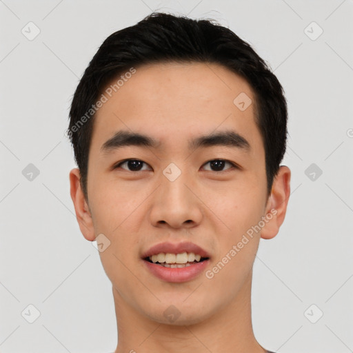 Joyful asian young-adult male with short  black hair and brown eyes