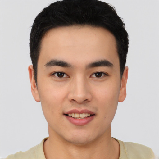 Joyful asian young-adult male with short  black hair and brown eyes
