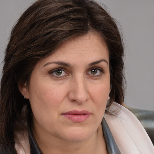 Joyful white adult female with medium  brown hair and brown eyes