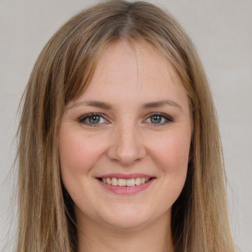 Joyful white young-adult female with long  brown hair and grey eyes